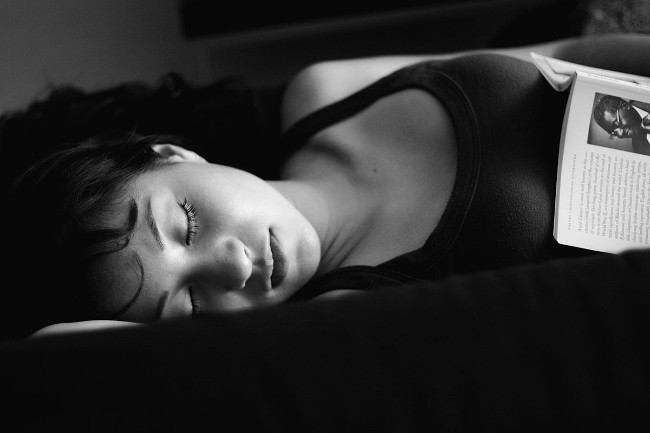 Jackie Martinez in BW sleeping with a book